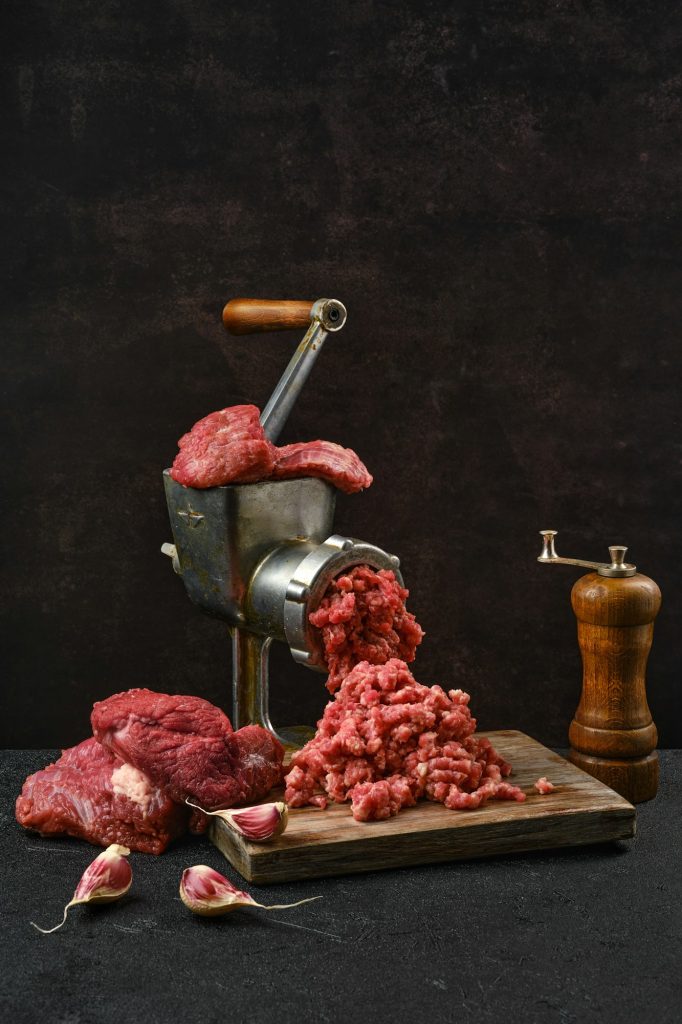 Making minced beef meat with meat grinder